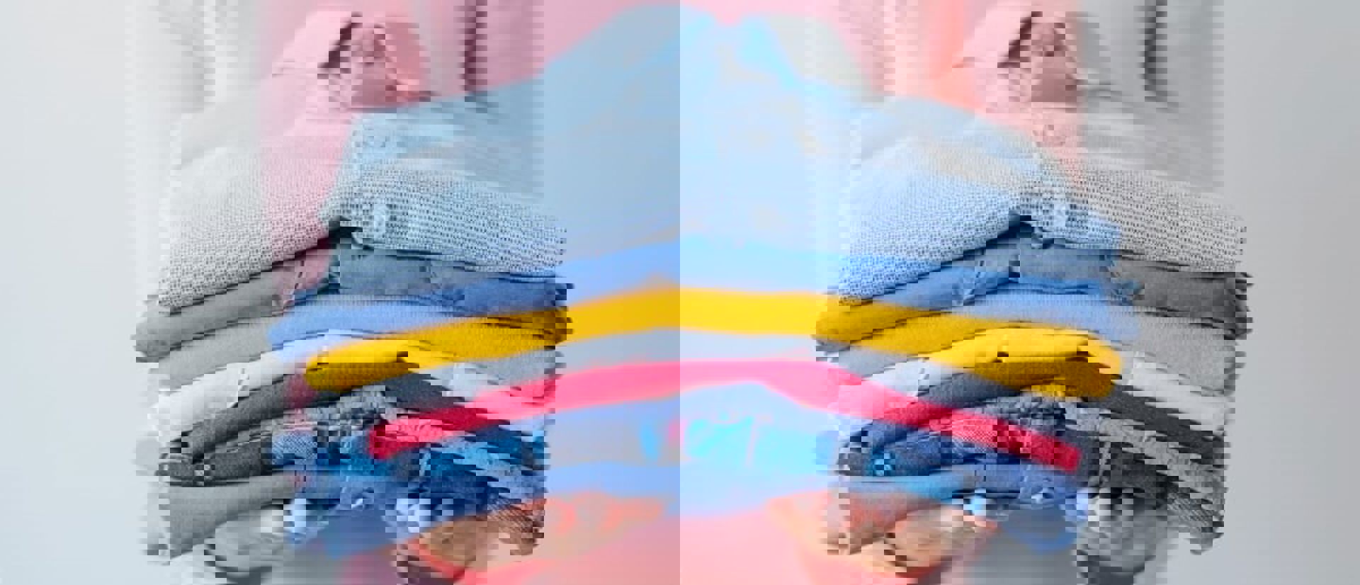 Girl Holding Pile Of Washed And Ironed Clothes Min